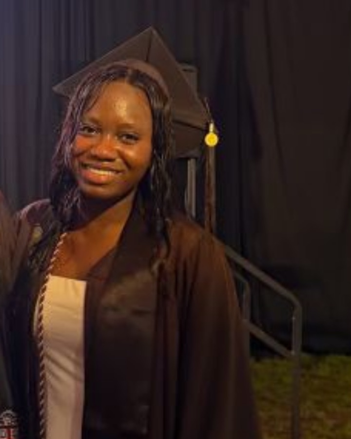 Tomi in her Brown cap and gown at graduation